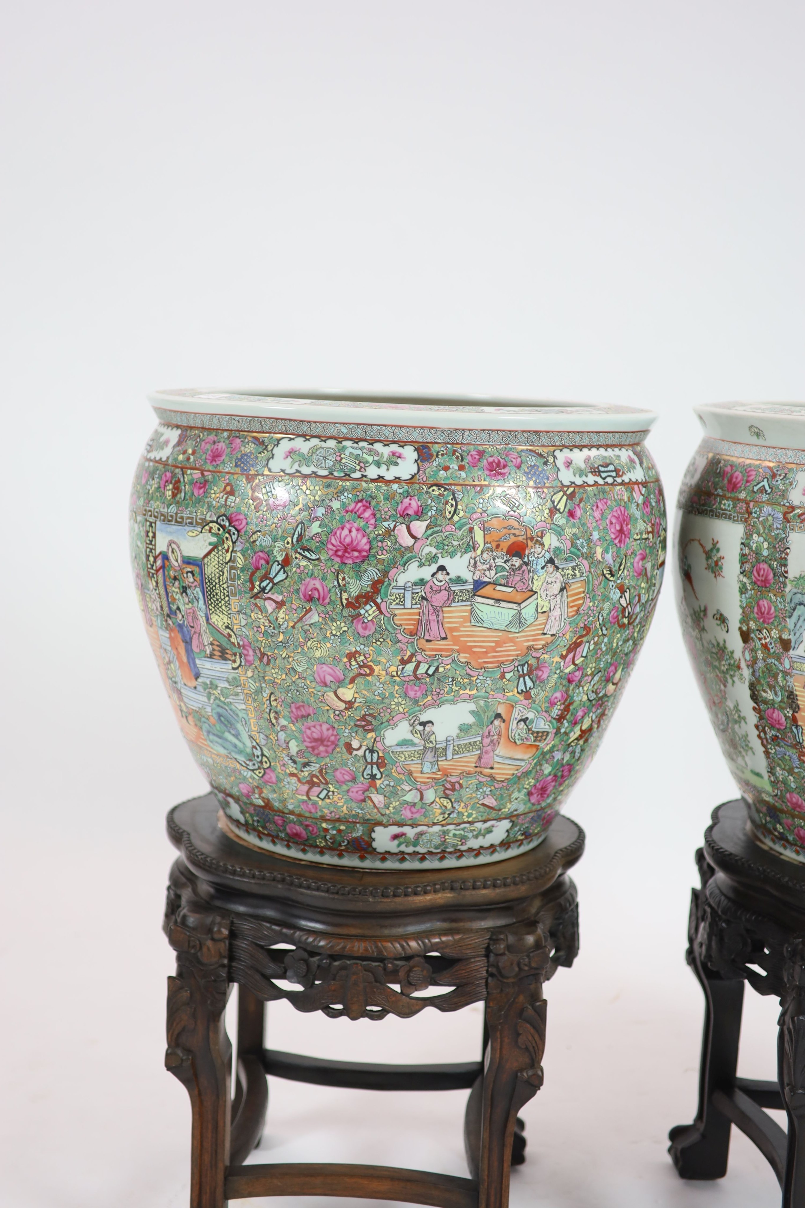 A pair of Chinese famille rose fish bowls on ebonised marble inset stands, diameter 56cm, total height 91cm